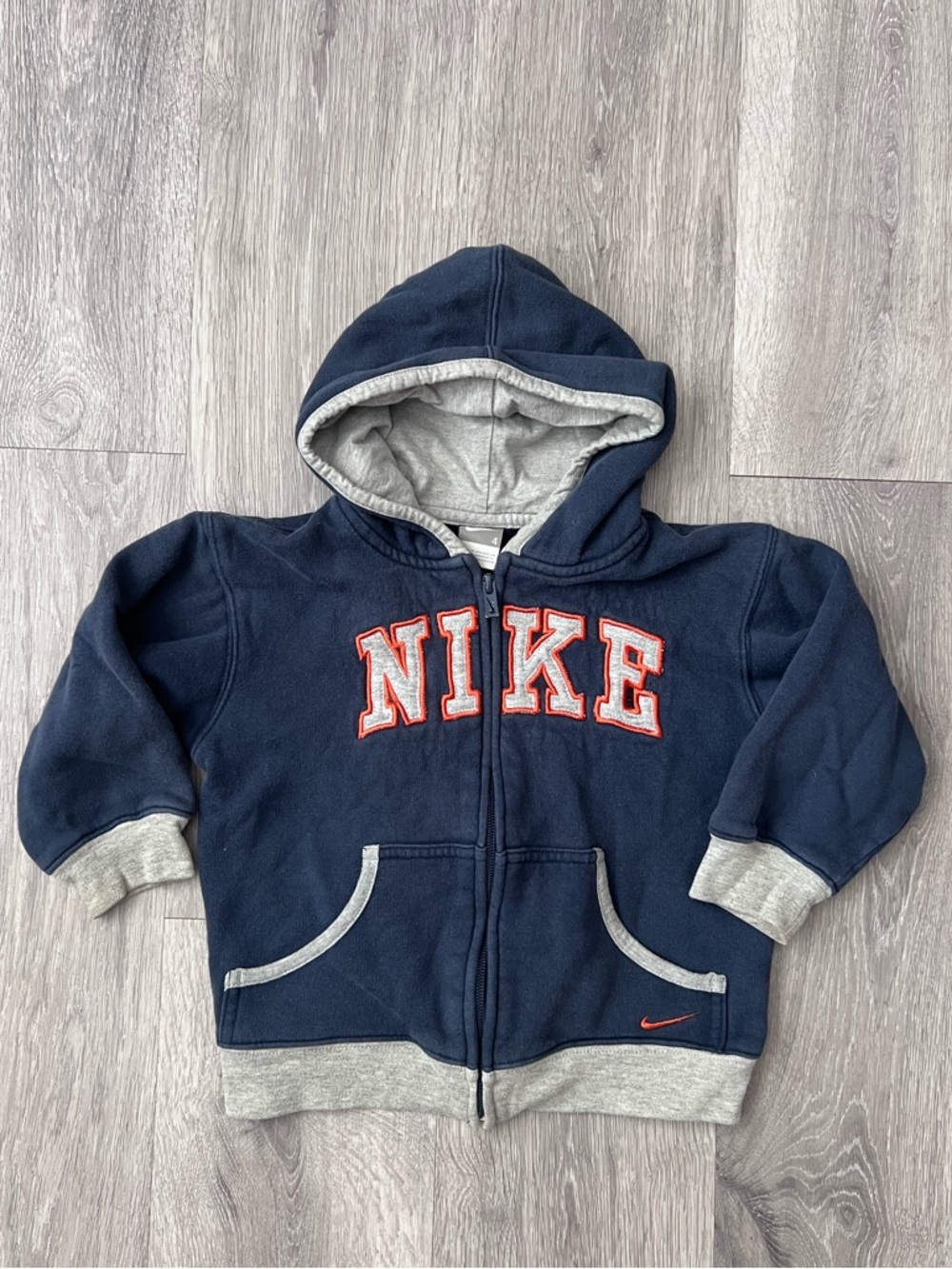Nike Kids Navy Blue Hooded Zip-Up Sweatshirt with Gray Trim and Orange Logo